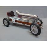 A chrome table top model of a vintage racing car.