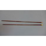 An 18 ct gold mounted walking cane and similar gold cane