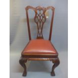 A set of four Chippendale style mahogany dining chairs raised on ball and claw feet.