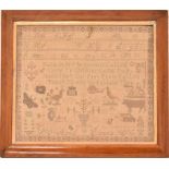 A 19th century needlework sampler in a maple frame