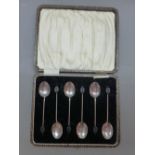 A cased set of silver coffee bean spoons, Birmingham together with a set of 4 silver napkin rings,