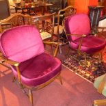 A pair of 20th Century Ercol armchairs having red velour upholstery cushions
