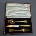 A George IV Paul Storr silver gilt knife, fork and spoon set.