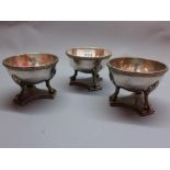 Three 19th Century Sheffield silver plated salt with ball and can feet raised on plinth base