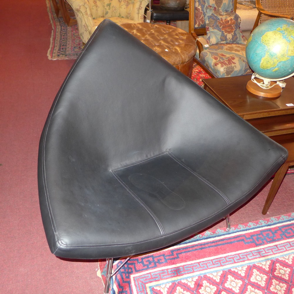 A George Nelson style coconut chair with black leather upholstered white perspex raised on chrome