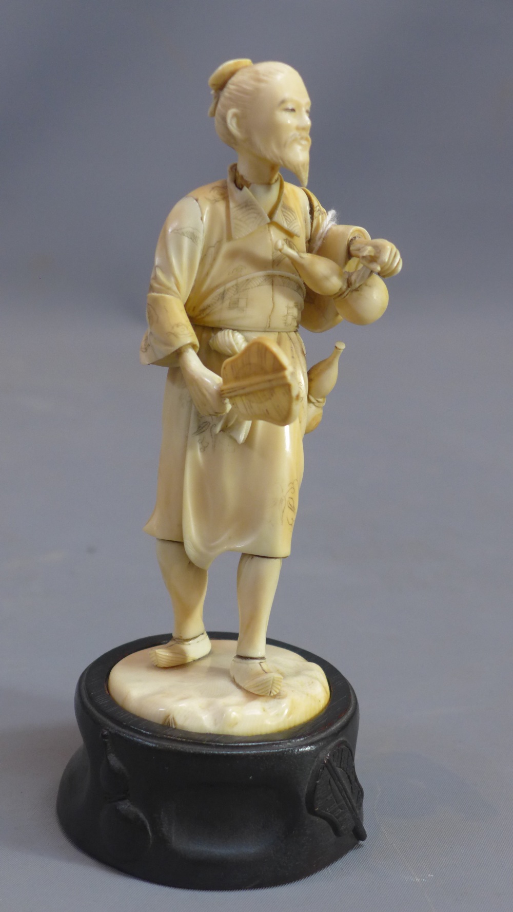 A 19th Century Japanese ivory carving of a man carrying two gourds and a fan. - Image 3 of 6