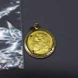 A George V 1913 gold sovereign pendant, set within an Egyptian yellow gold loose mount, approx.