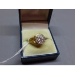 A ladies 1970s Cartier yellow gold and diamond dress ring, the band of wrythen design,