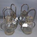 A set of four storm lanterns in the form of oil lamps.