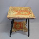 A two tier gypsy table having tapestry coverings.