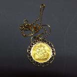 A George V 1913 gold sovereign, set within a 9ct gold mount, suspended on a 9ct yellow chain,