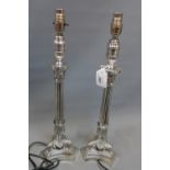 A pair of sliver plated empire style table lamps on triform base wired and P.A.T.