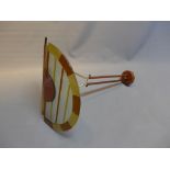 An art deco style drop down ceiling light with orange and brown glass shade.