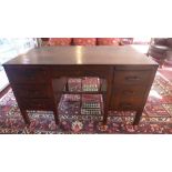 A Mid 20th century oak desk, frieze drawer flanked by an arrangement of three drawers to each side,