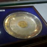 A modern parcel-gilt College of Arms commemorative silver plate, By YM, London 1977, circular form,
