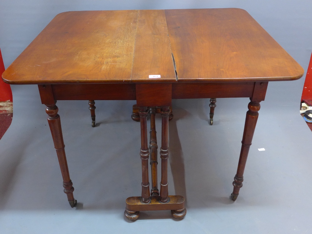 A 19th Century mahogany Sutherland table raised on turned legs and castors joined by stretchers.