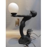 An art deco style table lamp in the form of a mermaid.
