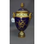 A 19th Century Coalport porcelain urn and cover hand painted with central still life of fruit