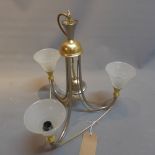 A contemporary regency style brass three branch chandelier with fixed glass shades