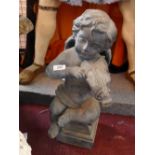A 19th Century terracotta statue in the form of a cherub playing a violin