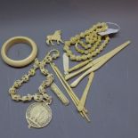 A job lot of ivory items to include glove stretchers, bangles etc.