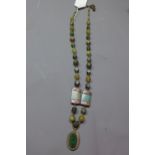 A ladies long Egyptian Jade and Nubian silver necklace having oval silver pendant inset with Jade.