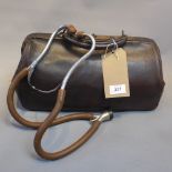 A vintage doctors leather gladstone bag dating from the 20th Century together with a doctors