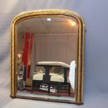 An early 20th Century over mantel mirror with partial gilding and having bevelled glass plate.