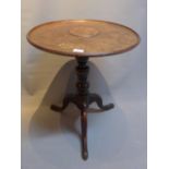 A 19th Century mahogany circular tilt top table, raised on tripod base.