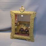 An early 20th Century gilt wood mirror in the Rococo taste.