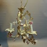 A white painted wrought iron three branch chandelier with floral decoration