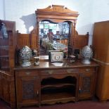 A Victorian oak mirrored back sideboard with three drawers above two carved cupboard doors and
