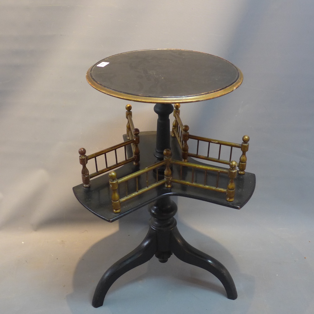 A Victorian ebonised occasional table with partial gliding, raised on three splayed legs.