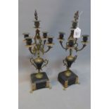 A pair of 19th Century gilt metal candelabras raised on slate and marble bases.
