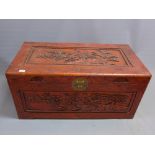 A 20th Century Chinese camphor wood chest carved with fruit and fauna.