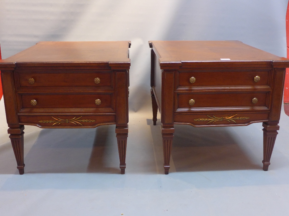 A pair of regency style walnut side chests of two drawers raised on reeded tapered legs.