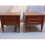 A pair of regency style walnut side chests of two drawers raised on reeded tapered legs.