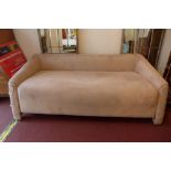 A contemporary Art Deco style three seater sofa with beige alcantara upholstery.