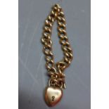 A ladies Egyptian gold bracelet having heart shaped charm marked '15'.