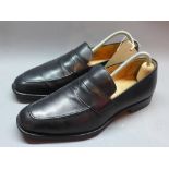 A pair of men's black leather loafers by Church's. Size 9.