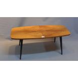 A 1950's teak top coffee table raised on tapered ebonised legs.