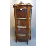 An early 20th Century French walnut vitrine with ormolu mounts and raised on cabriole legs.