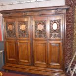 A late 18th Century oak Bibliotheque with four doors carved with flowers and acorns,