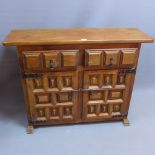 A Gothic style oak side cabinet with two drawers above cupboard doors.