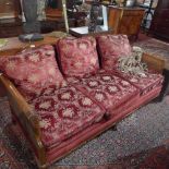 A late 19th century walnut bergere three seater sofa with floral upholstery having double caned