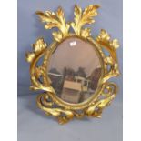 An 18th Century style gilt framed mirror with carved leaf border.