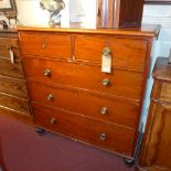 A Victorian mahogany chest of two short over three long drawers raised on bun feet,