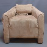 A contemporary Art Deco style arm chair with beige alcantara upholstery.