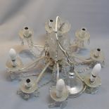 A vintage 20th century glass eight sconce chandelier having eight branches adorned with multiple