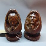 A pair of unusual carved wooden bookends in the form of winged angels in prayers raised on